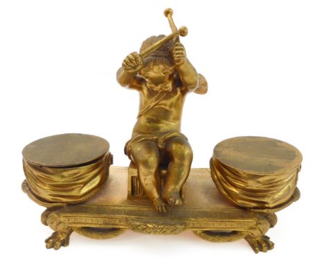 A large and heavy early 19th century ormolu double inkwell (probably French) - seated winged central cherubic figure bearing 