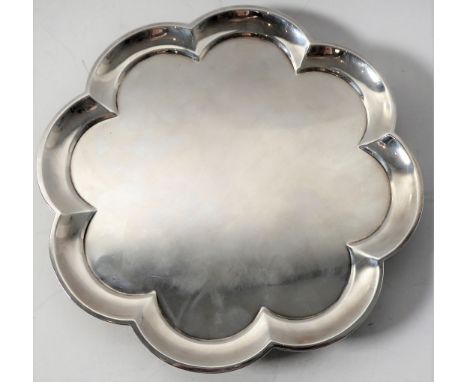 A heavy hallmarked silver salver of flowerhead shape and raised on four bun-style feet' maker's mark of Collingwood, 46 Condu