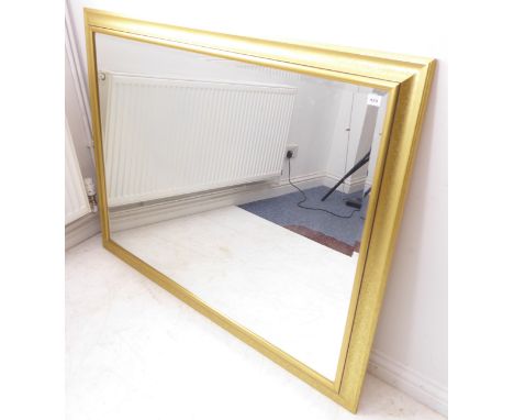 A large and modern gilt-framed wall-hanging mirror having hand-bevelled plate (103cm x 131.5cm)