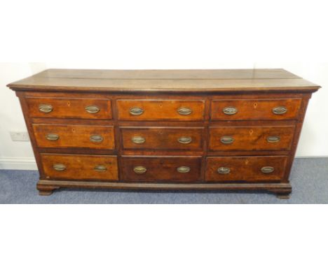 An 18th century oak Lancashire-style chest - the slightly overhanging moulded top above an arrangement of nine oak and walnut
