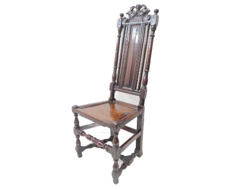A heavy and darkly patinated early 18th century oak side chair; the carved pierced scrolling top rail with the date 1723 abov