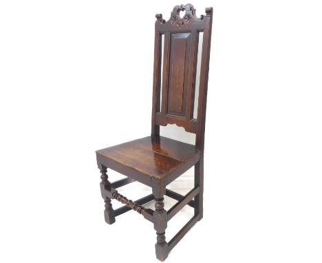 An early 18th century oak side chair; the top rail unusually centrally pierced with a heart motif and flanked by two incised 