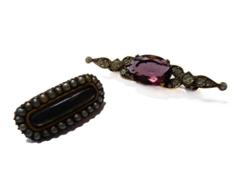 A Georgian yellow-metal oval mourning brooch with seed pearl border and a central lock of hair behind glass (2.5cm), together