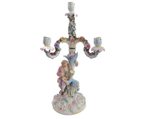 A late 19th century hand-decorated German porcelain four-light figural candelabra. The central vertical candle with three low