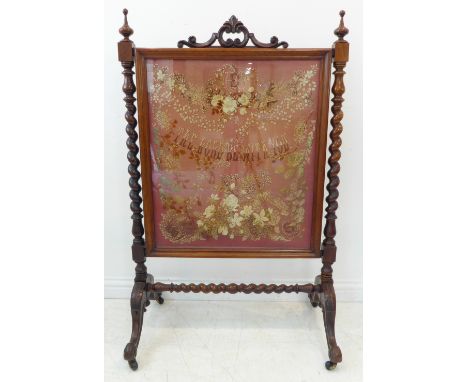 A mid 19th century rosewood fire screen of elaborate form and size; the pierced pediment with foliate centre above C-scrolls 