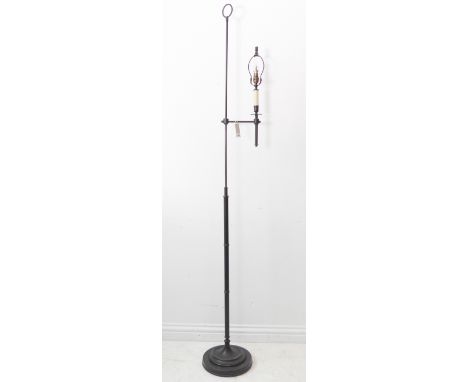 A free standing adjustable black painted iron lamp standard on circular base (189cm full height)