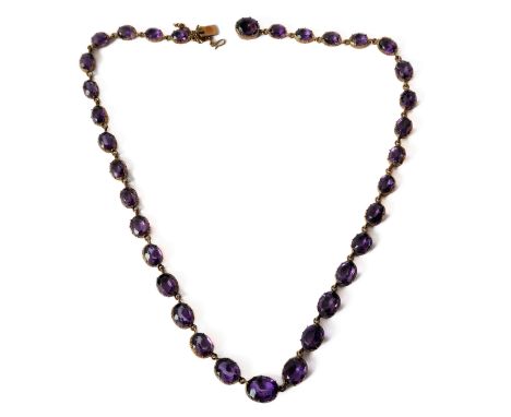 A 19th century amethyst collet necklace, each graduated oval amethyst within a yellow gold cut-down collet (overall length 38