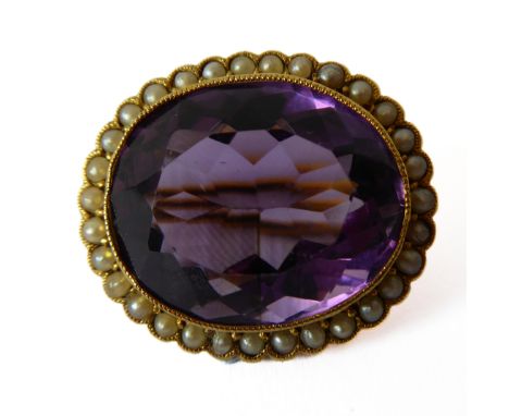 An Edwardian amethyst pearl and 15-carat yellow gold cluster brooch, the oval mixed-cut amethyst collet-set above the surroun