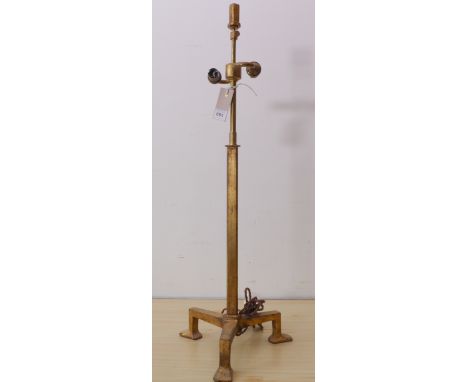 An unusual gilt metal adjustable-height double table lamp upon pronounced tripod base with elongated flat feet (75cm high)