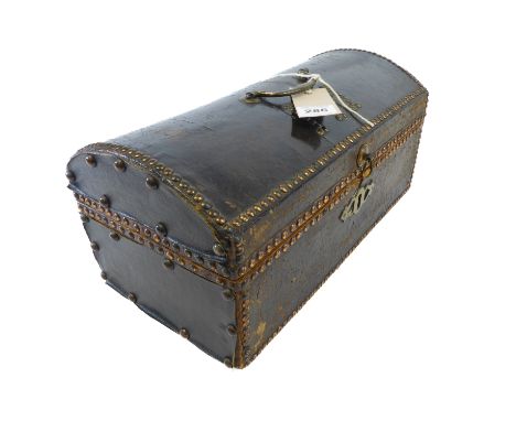 A late 18th century leather-covered copper-studded dome-top casket; the original brass swan-neck handle above studded letteri