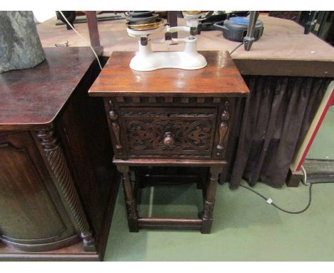 An 18th Century revival oak pot cupboard, the carved door with turned knob handle flanked by half turned mouldings on cannon 