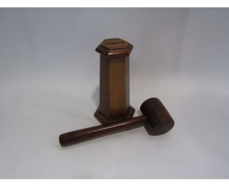 A wooden money box in the form of a tower and a wooden gavel