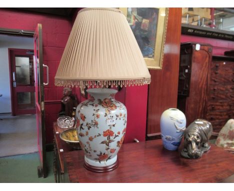 A large table lamp with floral decoration and a silk pleated shade and beaded fringe, 70cm tall