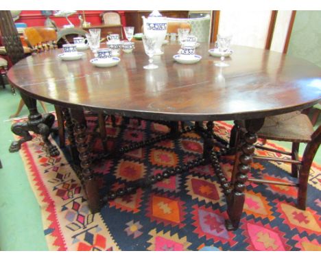 A Charles II and later oak oval top gate-leg dining table, the rising leaves over bobbin turned legs and stretchers