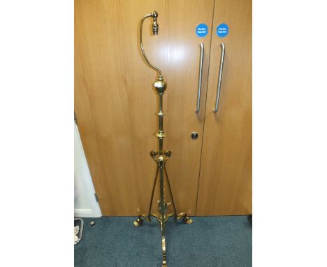 A Victorian brass tripod lamp standard with later conversion for electricity