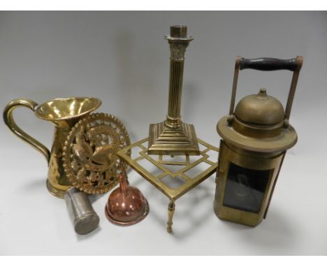 A late 19th century pierced brass bowed fire curb along with a tray containing various brass trivets, a pair of brass candles