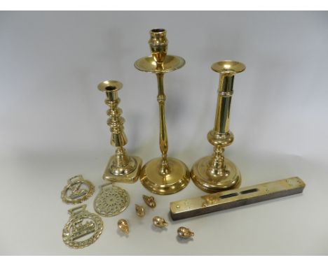 A tray containing various Victorian and other brass candlesticks along with a 19th century brass cased spirit level, various 