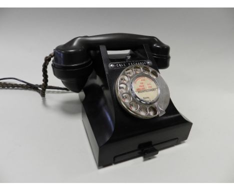 A 312L Bakelite telephone the dial centre titled Montgomery' with call exchange button above fitted for modern Telecom instal