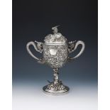 A CHINESE SILVER TWIN HANDLED CUP AND COVER