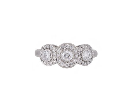 TIFFANY & CO., CIRCLETS, A DIAMOND RING  LONDON 2007  The triple diamond clusters, approximately 0.78 carats total, to a poli