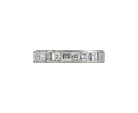 A MID 20TH CENTURY DIAMOND ETERNITY RING The band set with step cut diamonds, approximately 3.78 carats total, unmarked  Size