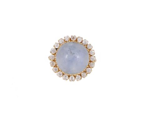 A STAR SAPPHIRE AND DIAMOND CLUSTER DRESS RING  The circular sugarloaf cabochon sapphire within a surround of old European cu