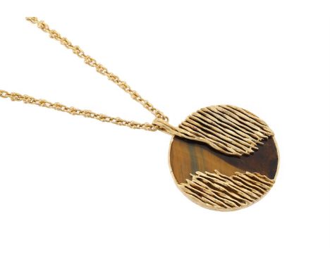 KUTCHINSKY, AN 18 CARAT GOLD AND TIGER'S EYE PENDANT ON CHAIN  LONDON 1972  The circular polished tiger's eye panel with appl