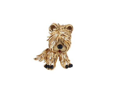 FRED, PARIS, A NOVELTY DOG BROOCH  The gold coloured dog with polished long coat and textured muzzle, black enamelled nose an