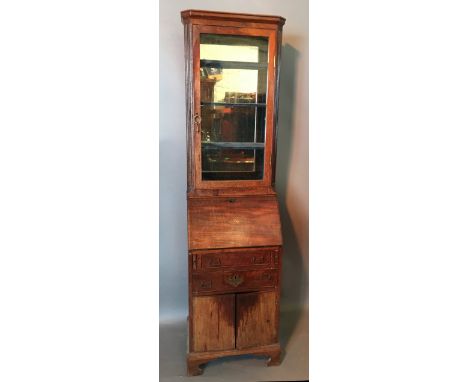 An 18th Century Mahogany Bureau Bookcase of narrow proportions, the moulded cornice above a single glazed door enclosing mirr