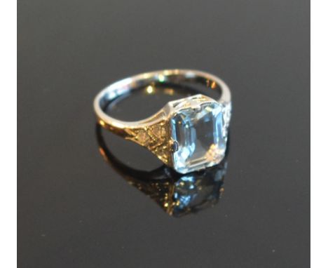 An 18ct. White Gold Aquamarine and Diamond Ring set with a rectangular aquamarine flanked by diamonds approximately 0.20 / 1.