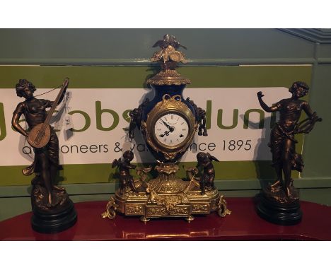 A Reproduction Gilt Brass Mantle Clock, the dial with Arabic numerals and with two train movement together with a pair of pat