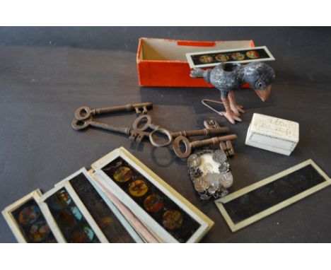 A Collection of Magic Lantern Slides, five early keys, a bone rectangular box, a patinated metal model in the form of a touca