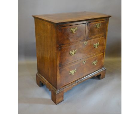An 18th Century Style Walnut Chest, the herringbone cross banded top above two short and two long drawers with cross banding,