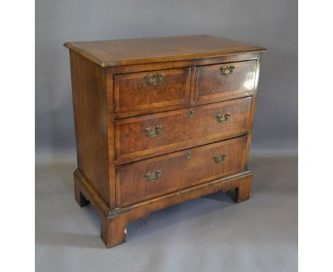 An 18th Century Style Walnut Chest, the herringbone inlaid top above two short and two long drawers with brass handles and es