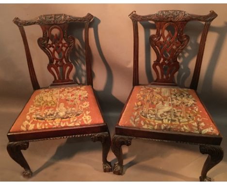 A Pair of Chippendale Style Side Chairs with carved splat backs above tapestry drop in seats raised upon cabriole legs with b