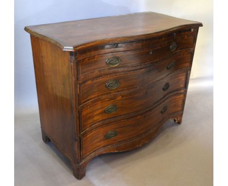 A George III Mahogany Serpentine Commode, the cross banded moulded top above a brushing slide and three graduated drawers wit