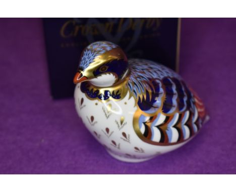 A ceramic Royal Crown Derby paper weight or figure of a Red Leg Partridge having gold stopper and box