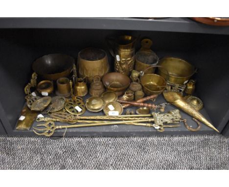 A selection of brass wares including fire side items and decorated planter