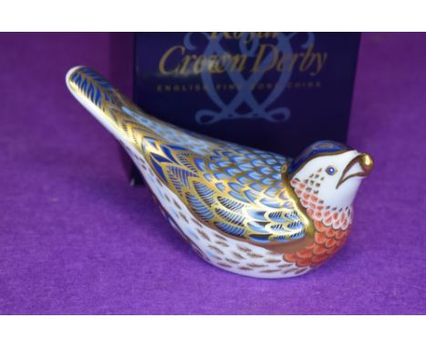 A ceramic Royal Crown Derby paper weight or figure of a Bluebird having gold stopper and box