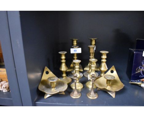 Six pairs of brass candle sticks including push bottom and chamber stick style