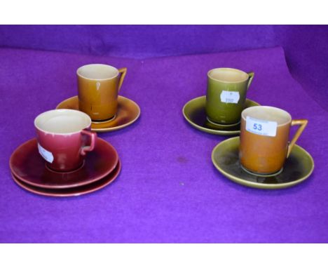 Three coffee cans, five saucers and one tea cup by Linthorpe pottery in designs by Christopher Dresser