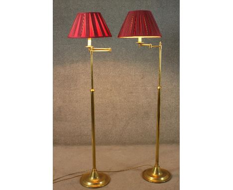 A pair of vintage brass height adjustable standard lamps with extending arms and circular base. H.166cm. 