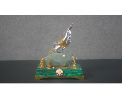 A bespoke Royal Insignia white and gilt metal figure of a pearl diver with gold plated shorts, basket, sea weed and rope. Stu
