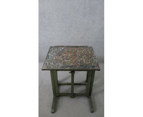 A 19th century Sheraton revival green painted metamorphic artist's easel table, of the type made by Roberson &amp; Co, 99 Lon