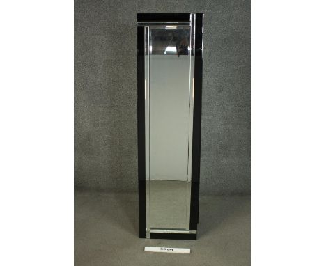 An Art Deco style frameless dressing mirror, of elongated form, with faceted mirrored and black glass frame, on an easel type