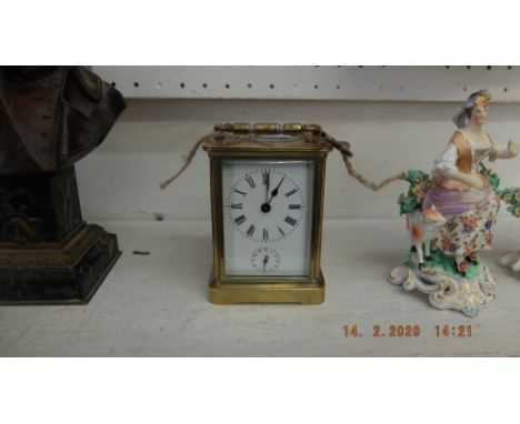 A Victorian brass alarm carriage clock