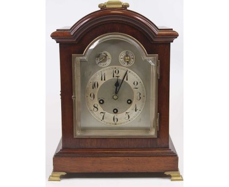 An early 20th century mahogany cased bracket clock, having an arched dial with silvered chapter ring, Arabic numerals, chime/