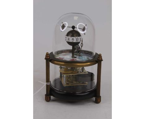 A reproduction automaton clock, the globular hour aperture surmounted by two fish above an enamelled panel with visible movem