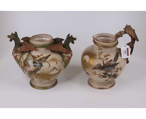 An Alfred Stellmacher twin-handled porcelain vase, the handles in the form of dragons, the body painted with a bird before a 