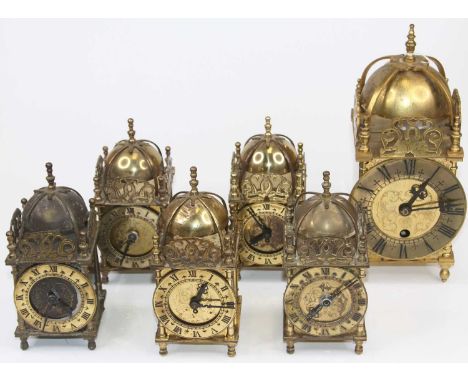 A brass cased lantern clock in the 17th century style, having a strapwork bell top within pierced brass spandrels, the brass 